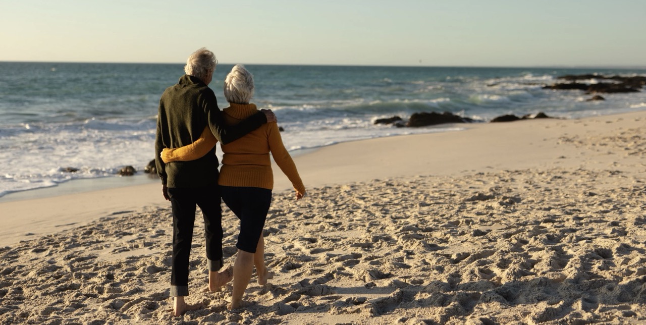Couple walking arm-in-arm on Boca Raton beach